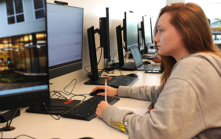 A student working on a desktop computer.